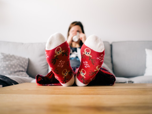 woman in sock feet and pajamas